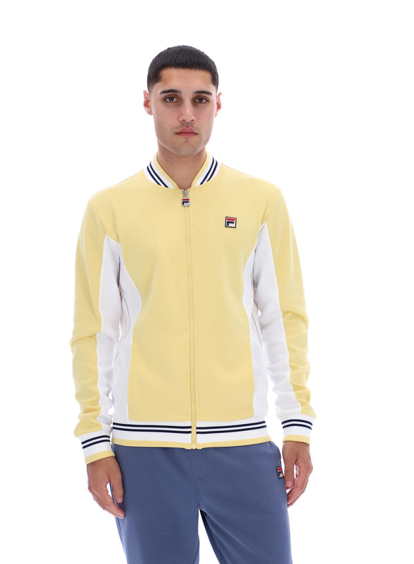 Man wearing a yellow and white jacket with a logo on a white background