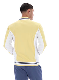 Man wearing a yellow and white jacket with blue pants on a white background