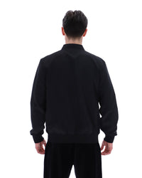 Display a model wearing the Black 'Fila' branded Smith Archive-Inspired Jacket