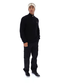 Displays a model wearing the Black 'FILA' branded Stevie 1/4 Zip Funnel Neck Textured Knit