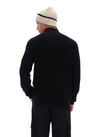 Displays a model wearing the Black 'FILA' branded Stevie 1/4 Zip Funnel Neck Textured Knit