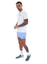 Man wearing a white t-shirt and light blue shorts on a white background