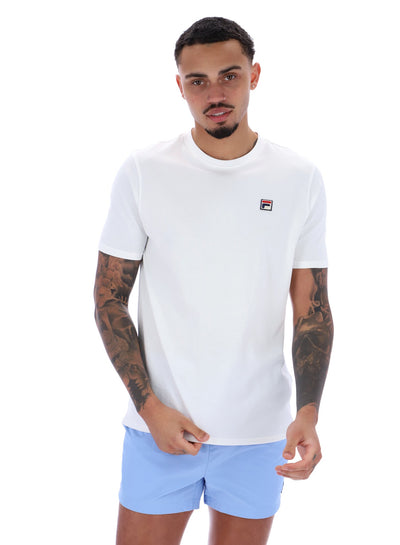 Man wearing a white t-shirt with a logo and light blue shorts on a white background