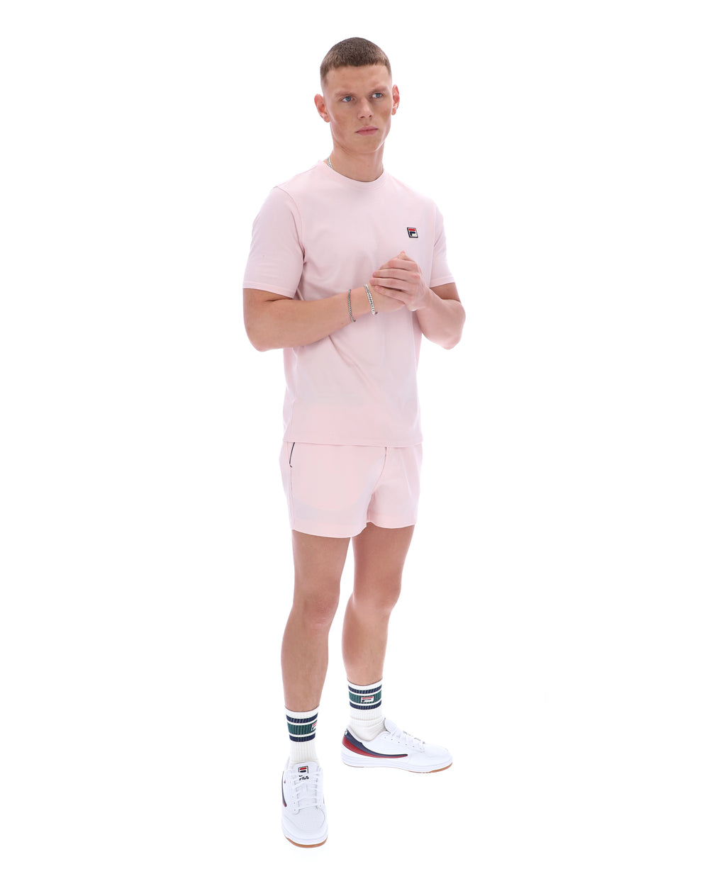Man wearing a pink outfit with a logo on a white background