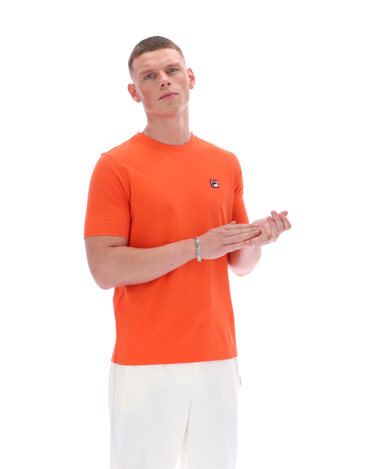 Man wearing an orange t-shirt with a logo on a white background
