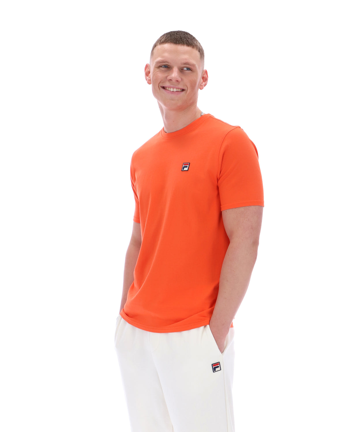 Man wearing an orange t-shirt with a logo on a white background