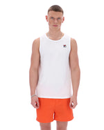 Man wearing a white sleeveless shirt and orange shorts on a white background