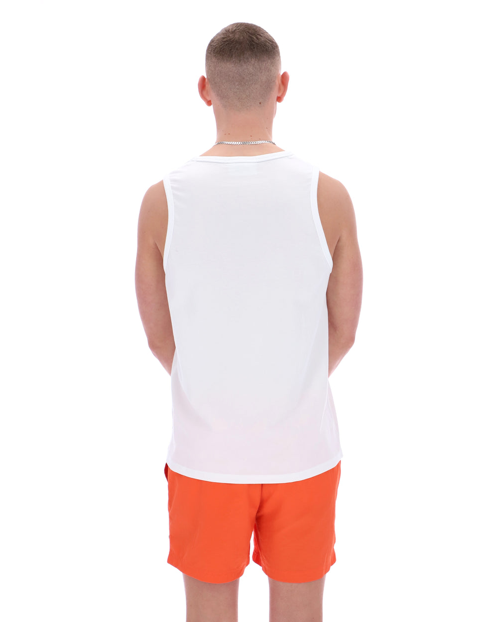 Man wearing a white sleeveless shirt and orange shorts on a white background