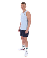 Man wearing a light blue sleeveless shirt and navy shorts on a white background