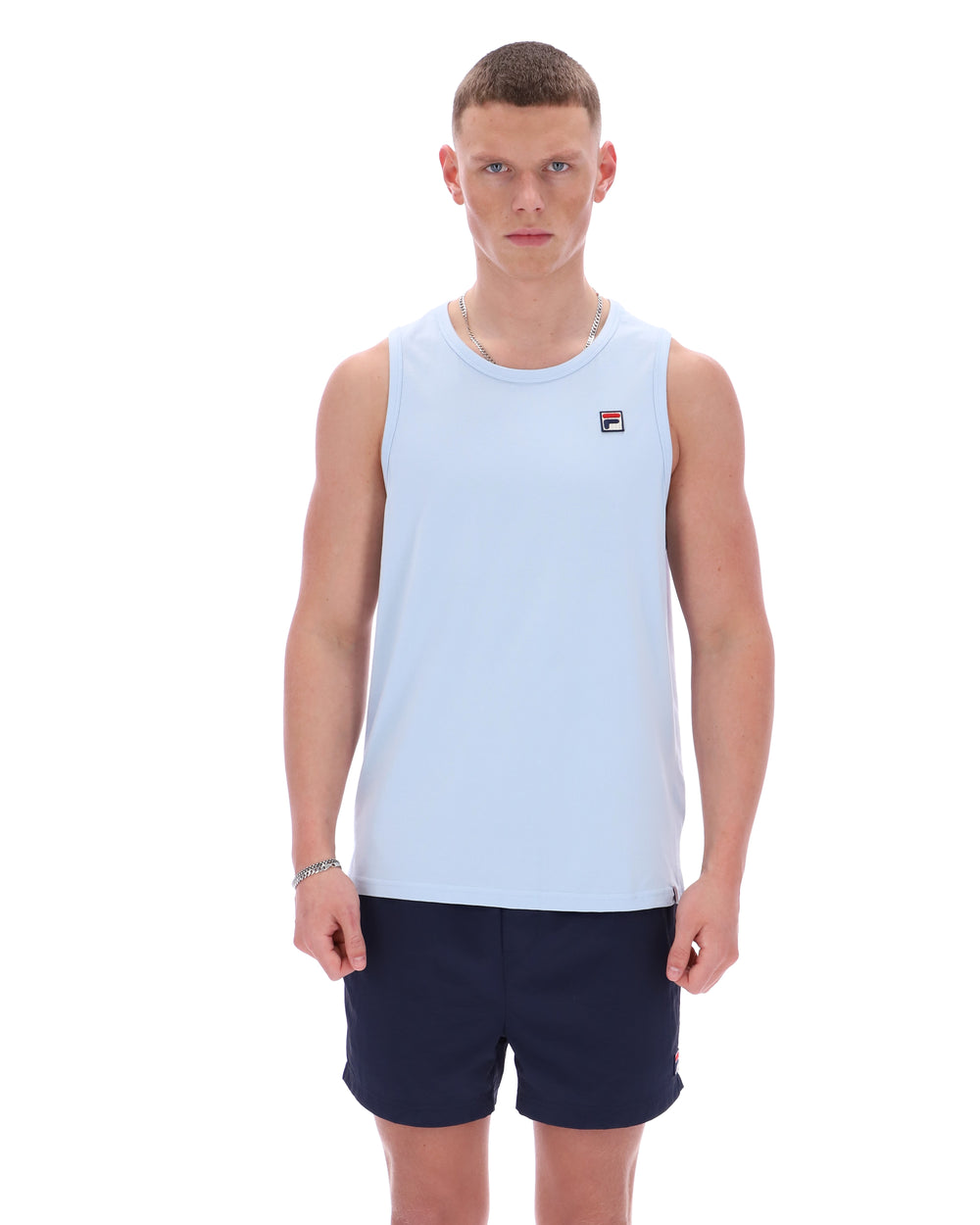 Man wearing a light blue sleeveless shirt with a logo on a white background