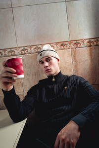 Displays a model wearing the Black 'FILA' branded Stevie 1/4 Zip Funnel Neck Textured Knit
