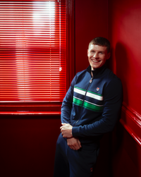 Displays a model wearing the Navy 'FILA' Vinnie Track Top