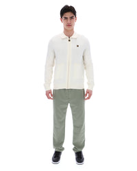 Displays a model wearing the Coconut Milk 'FILA' branded Teddy Knitted Shirt