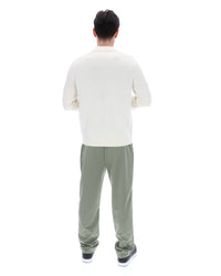 Displays a model wearing the Coconut Milk 'FILA' branded Teddy Knitted Shirt