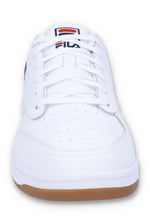 White sneaker with brown sole on a white background