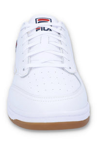 White sneaker with brown sole on a white background