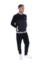 Man wearing a black tracksuit with white accents on a white background