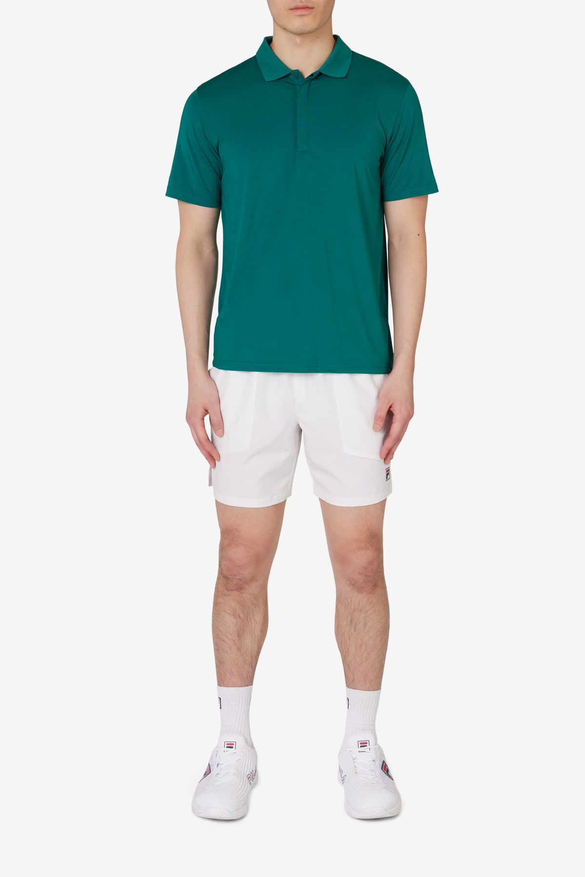 Displays a model wearing the Green 'FILA' branded Tennis Essentials Top