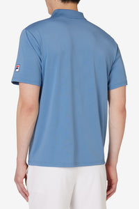 Displays a model wearing the Blue 'FILA' branded Tennis Essentials Top