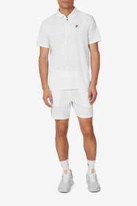 White short sleeve tennis polo with a collar, a zip-up shirt, and a FILA logo on the chest.