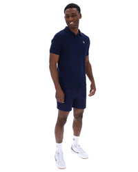 Displays a model wearing the Navy 'Fila' branded Tristiano Textured Polo