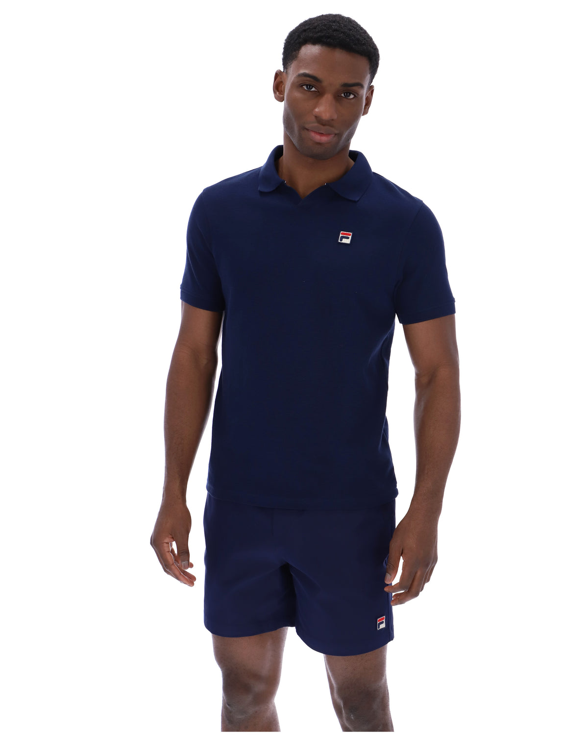 Displays a model wearing the Navy 'Fila' branded Tristiano Textured Polo