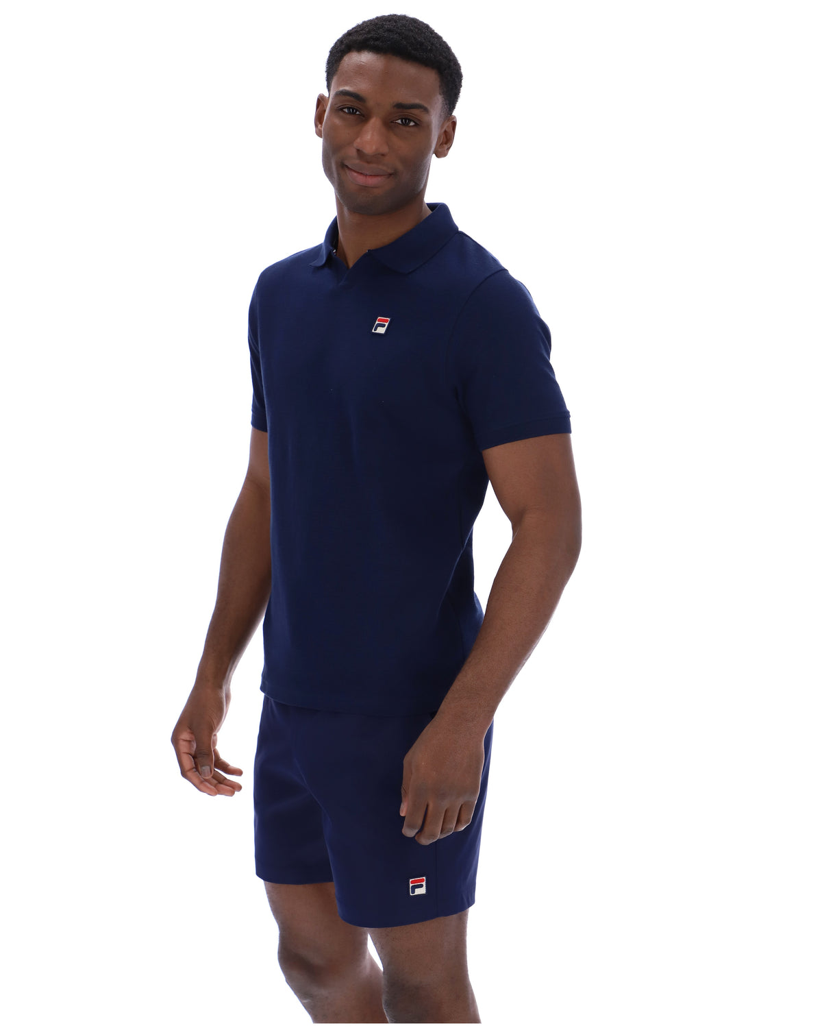Displays a model wearing the Navy 'Fila' branded Tristiano Textured Polo