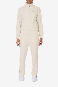 Displays a model wearing the Beige 'FILA' branded branded Tennis Advantage Track Top