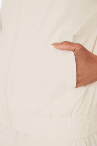Displays a model wearing the Beige 'FILA' branded branded Tennis Advantage Track Top