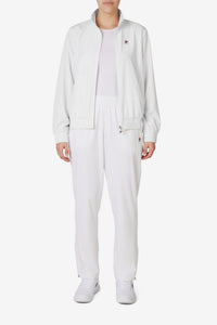 Displays a model wearing the White 'FILA' branded Tennis Advantage Track Pant