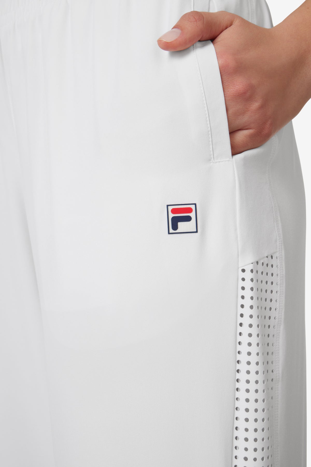 Displays a model wearing the White 'FILA' branded Tennis Advantage Track Pant featuring the FILA branded logo 