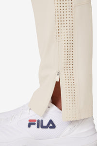 Displays a model wearing the Beige 'FILA' branded Tennis Advantage Track Pant