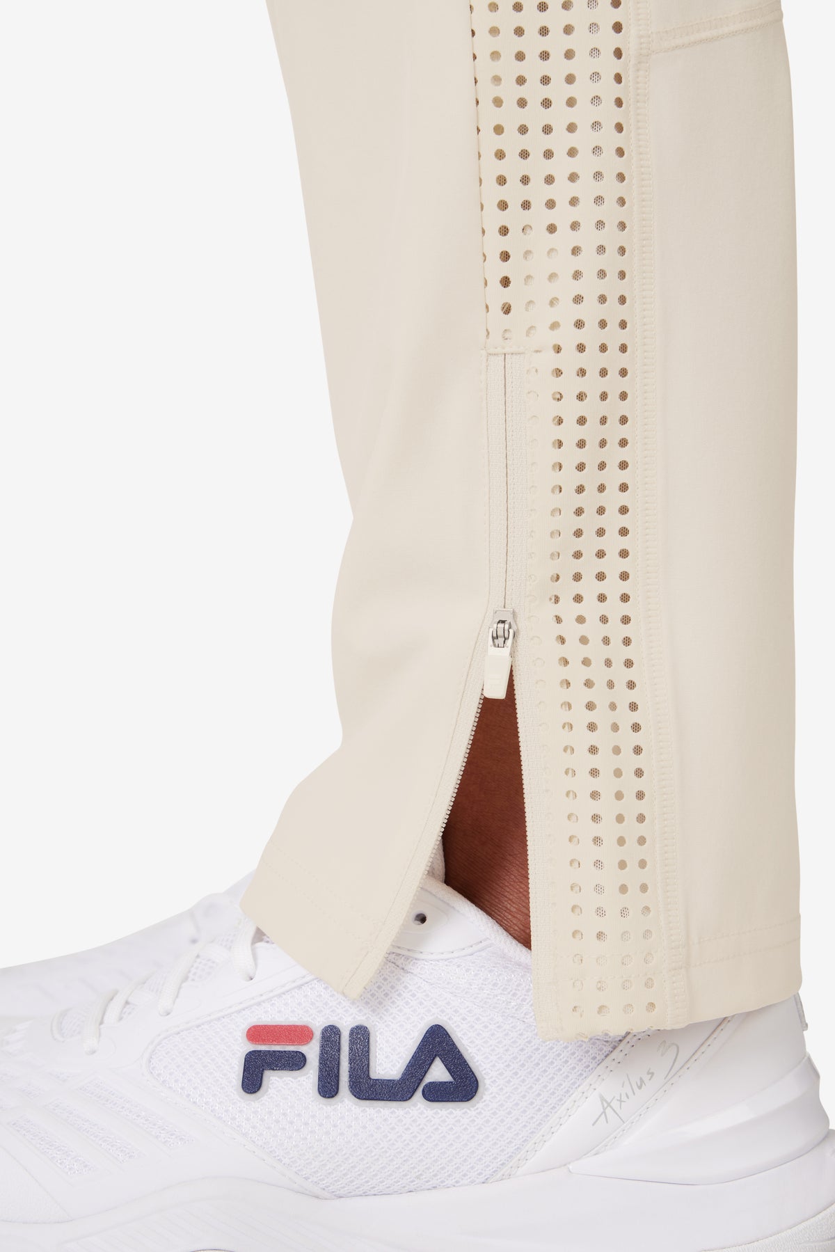 Displays a model wearing the Beige 'FILA' branded Tennis Advantage Track Pant