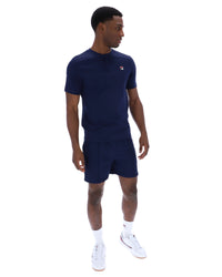Man wearing a navy blue outfit with a logo on a white background