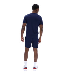Man wearing a navy blue outfit on a white background