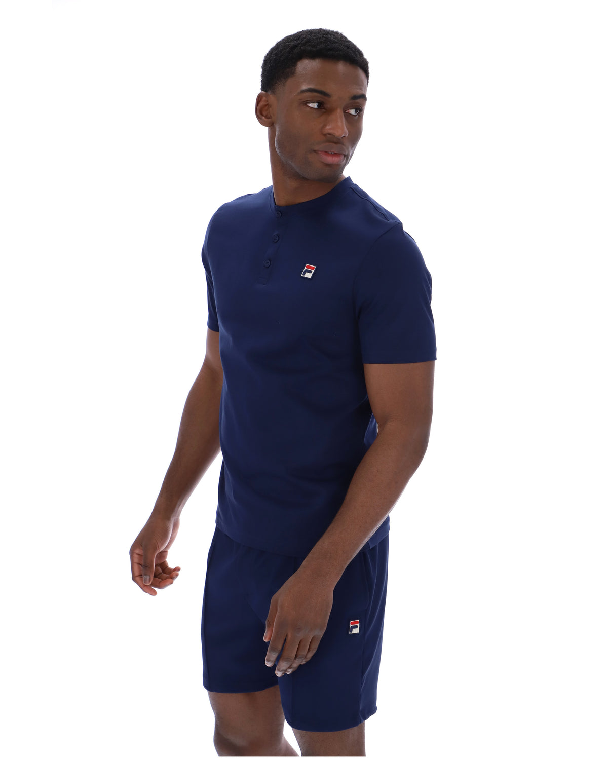 Man wearing a navy blue t-shirt and shorts with a logo on a white background