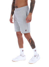 Model wearing Grey tracksuit shorts with FILA logo branding