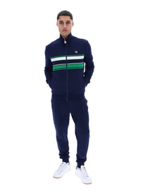 Displays a model wearing the Navy 'FILA' Vinnie Track Top