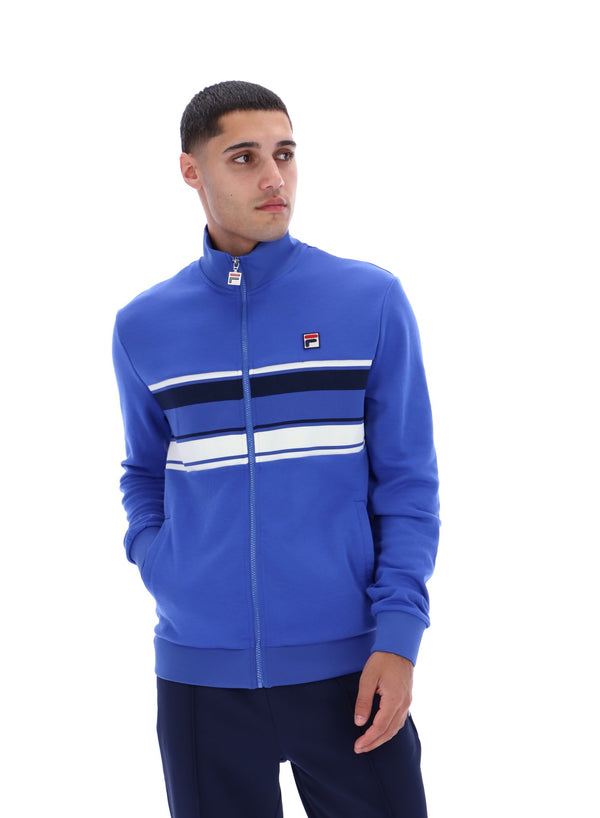 Displays the model wearing the Dazzling Blue 'FILA' branded Vinnie Track Top