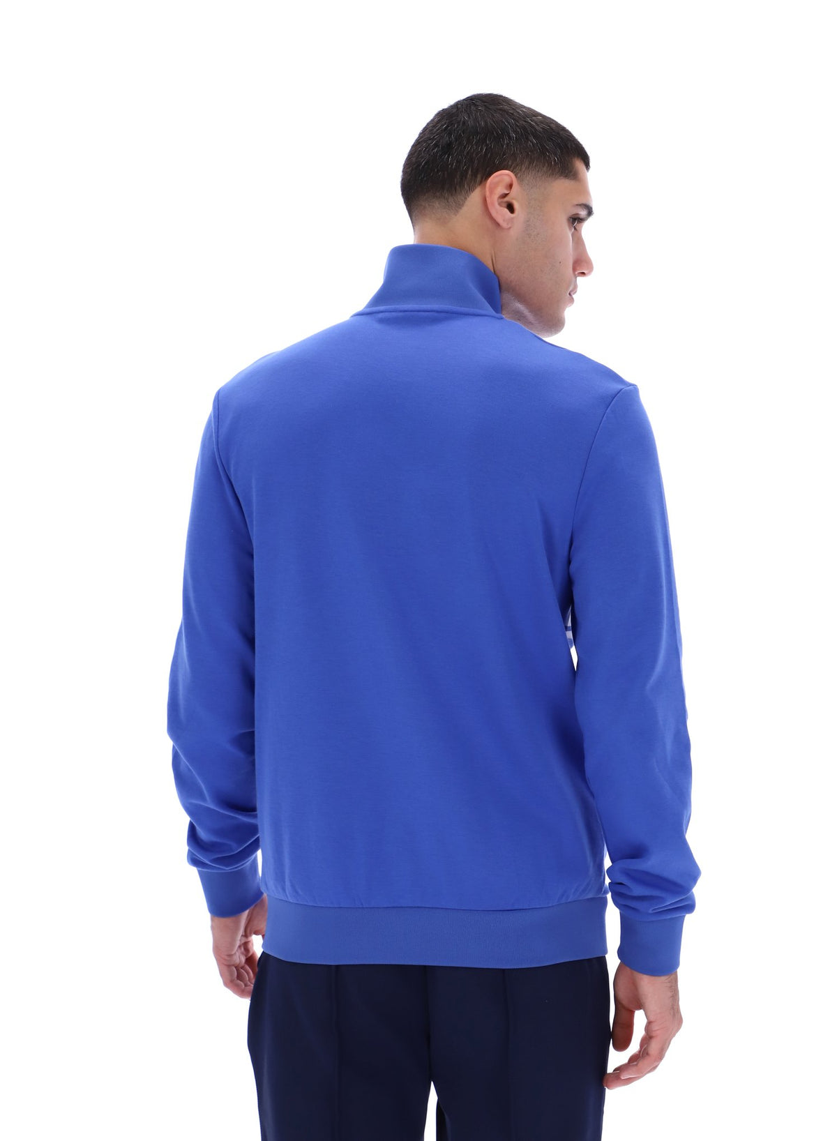 Displays the model wearing the Dazzling Blue 'FILA' branded Vinnie Track Top