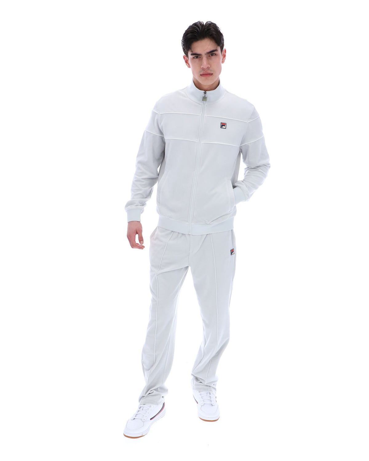 Displays a model wearing the Dawn Blue 'FILA' branded Vittorio Velour Track Top