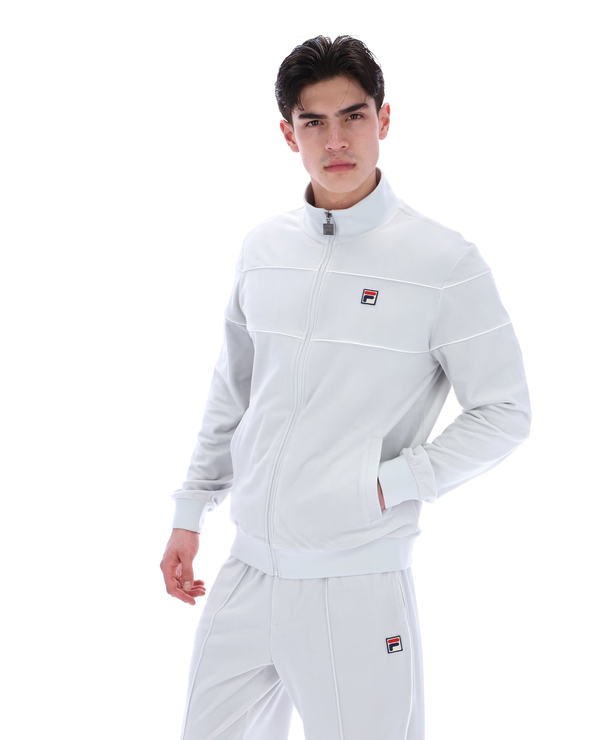 Displays a model wearing the Dawn Blue 'FILA' branded Vittorio Velour Track Top