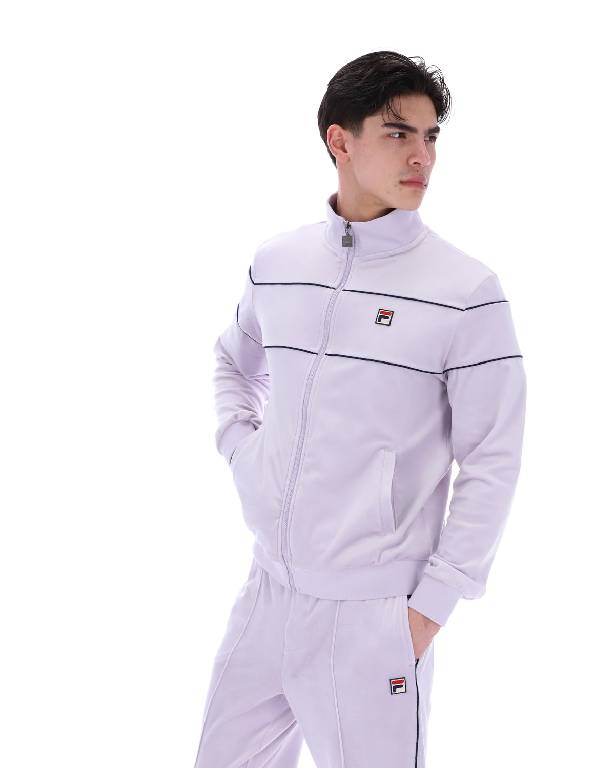 Displays a model wearing the Misty Lilac 'FILA' branded Vittorio Velour Track Top