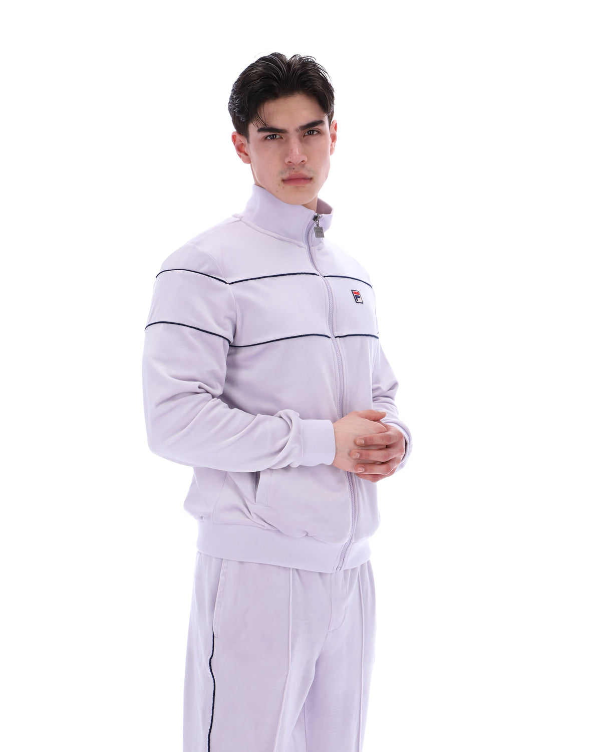 Displays a model wearing the Misty Lilac 'FILA' branded Vittorio Velour Track Top