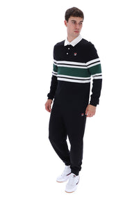 A young man modeling a black long-sleeve rugby-style polo shirt with green and white horizontal stripes on the chest and sleeves, paired with black joggers and white sneakers, against a plain white background.