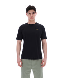 Displays a model wearing the Black 'Fila' branded Yaxley 4 Premium T-Shirt