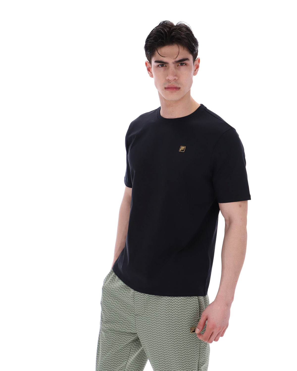 Displays a model wearing the Black 'Fila' branded Yaxley 4 Premium T-Shirt