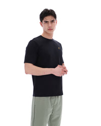 Displays a model wearing the Black 'Fila' branded Yaxley 4 Premium T-Shirt
