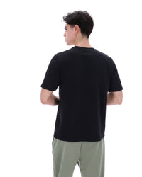 Displays a model wearing the Black 'Fila' branded Yaxley 4 Premium T-Shirt