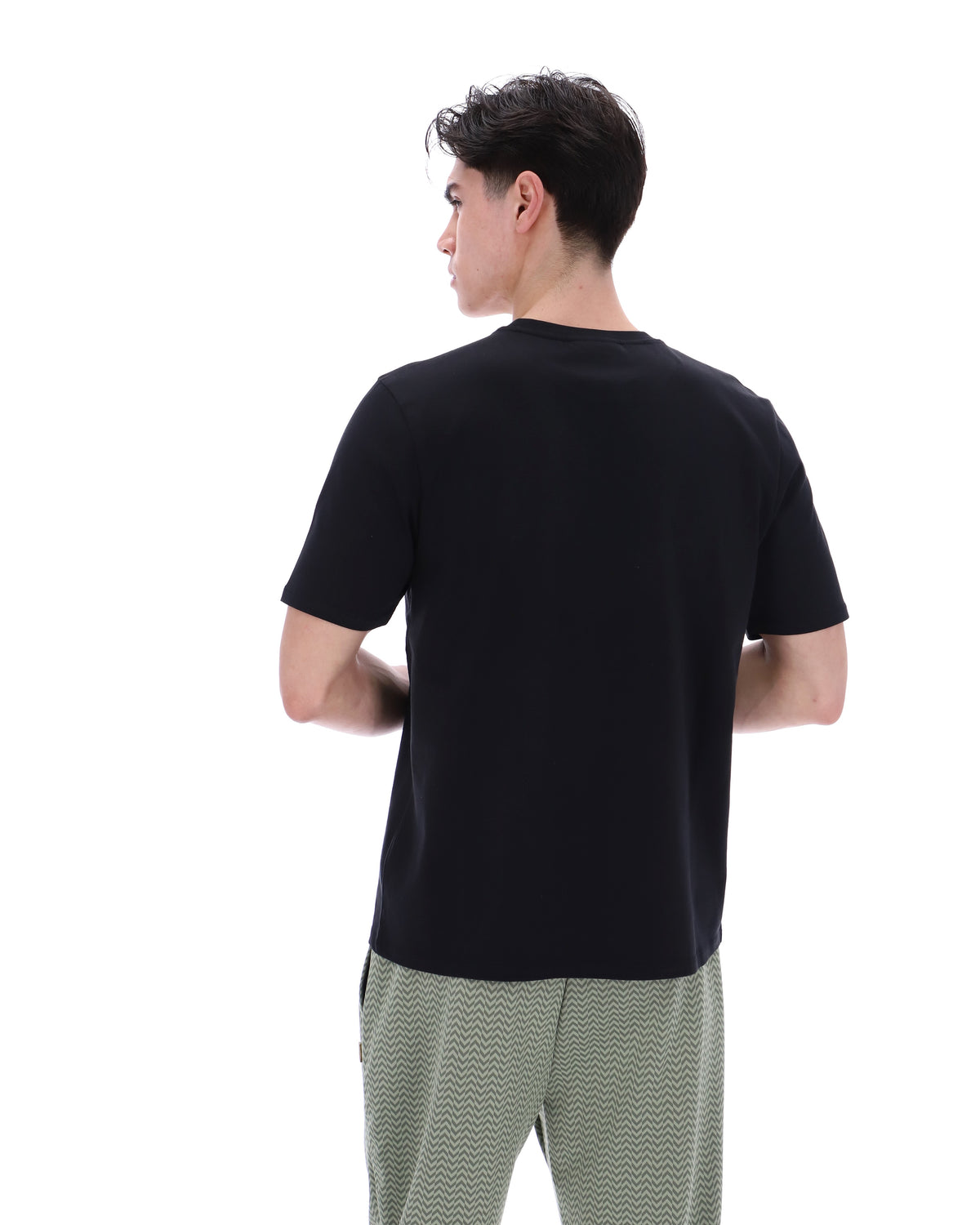 Displays a model wearing the Black 'Fila' branded Yaxley 4 Premium T-Shirt
